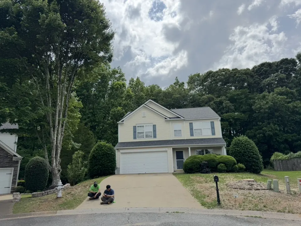 After: Crew posing in front of completed job showing maple removed and left tree pruned high in Acworth GA