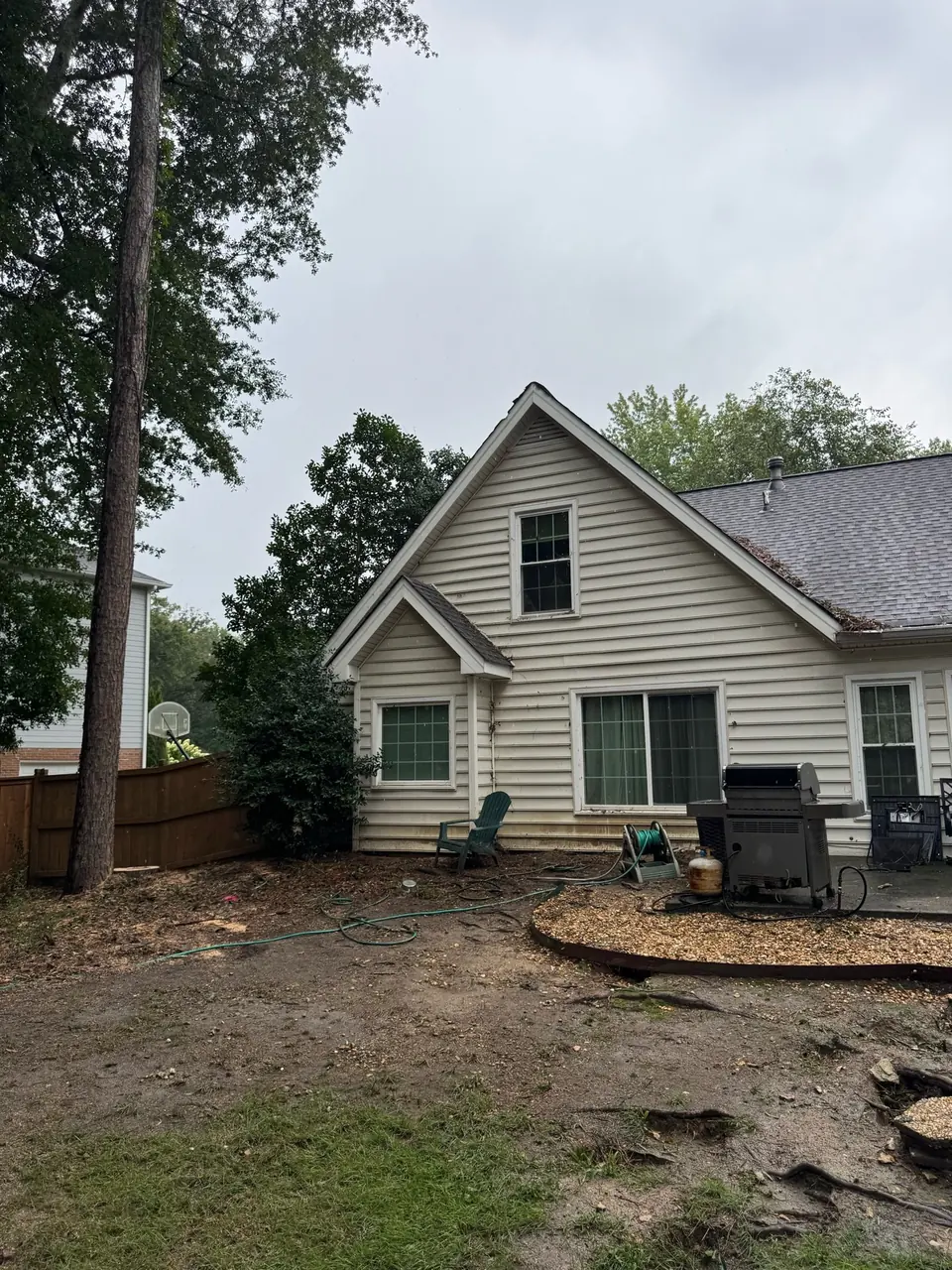 After: Clean yard with stump remaining, all debris hauled away