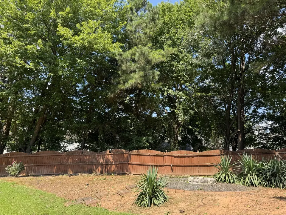 After: Fence cleared, overgrowth pruned back, standing straight in Kennesaw GA